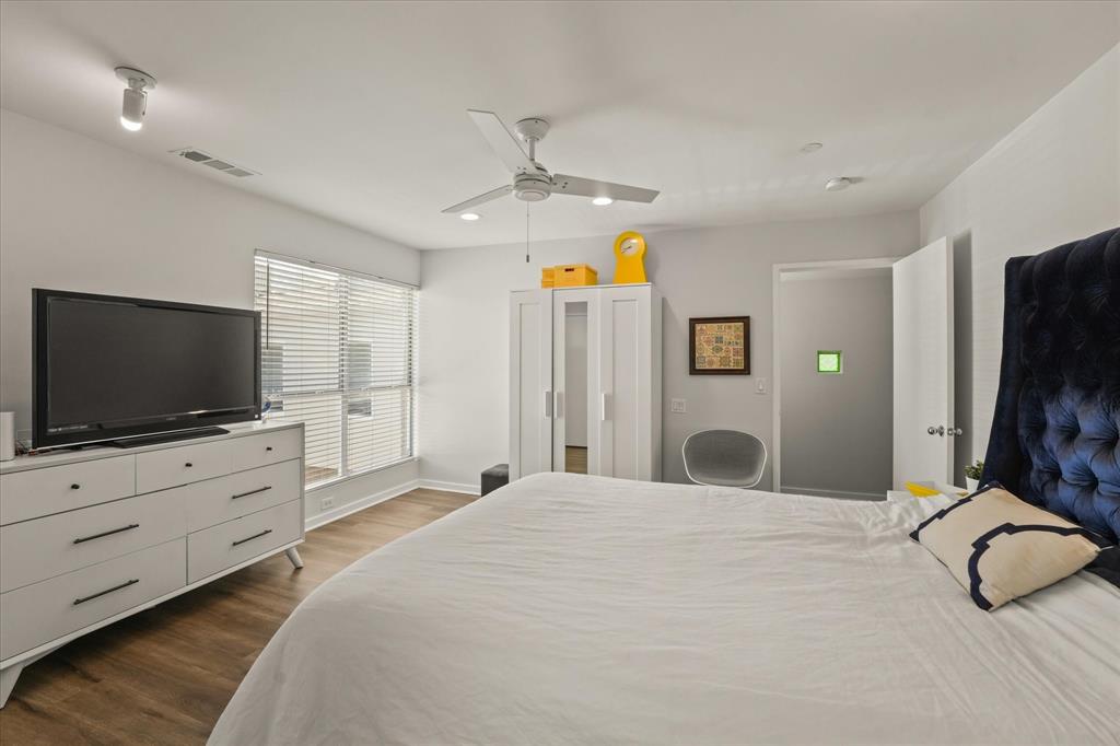 4231 Travis Street, Unit 29 Dallas, TX 75205 - Photo 32 of 39 a bedroom with a bed and a flat screen tv in it