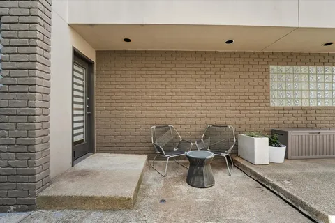 a view of a patio with couches and potted plants