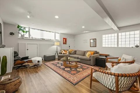 a living room with furniture a rug and a window