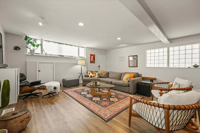 a living room with furniture a rug and a window
