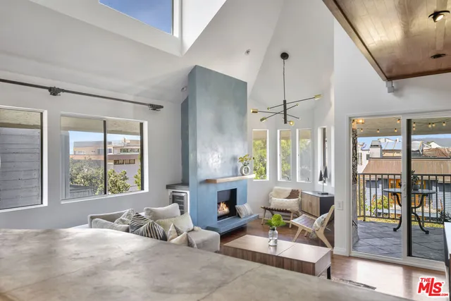 a bedroom with furniture and large windows