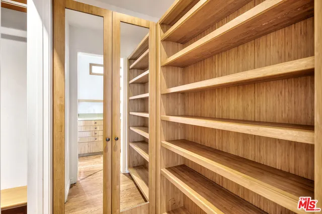 a bedroom with furniture and a wooden floor
