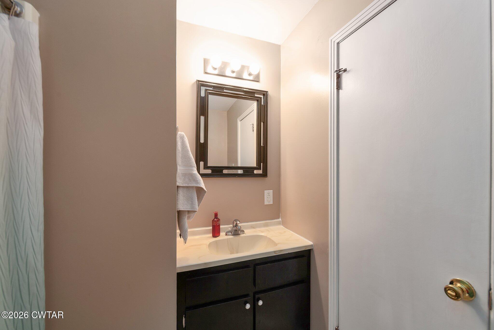 101 Wilde Road Pinson, TN 38366 - Photo 12 of 16 a bathroom with a sink and a mirror