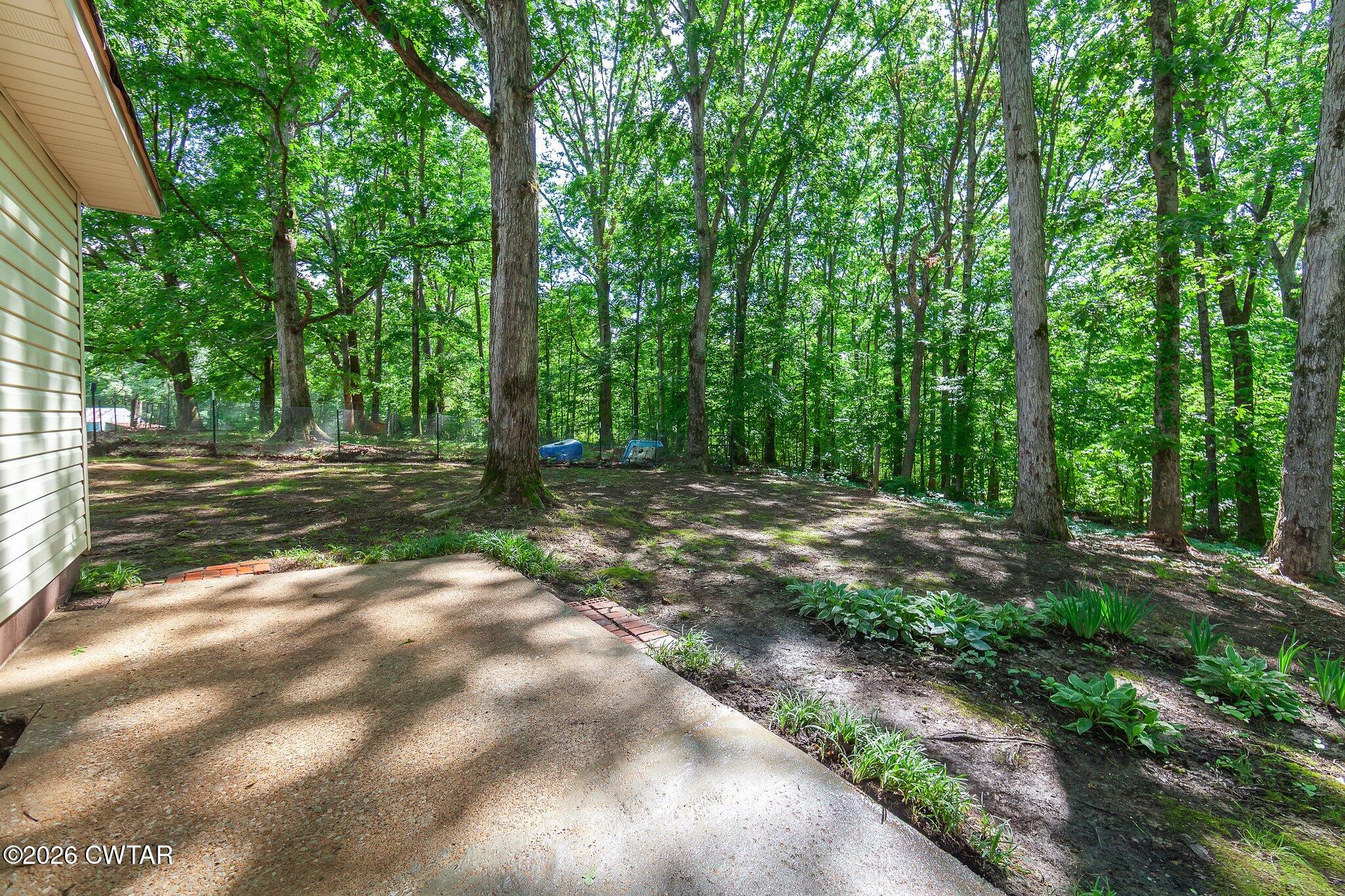 101 Wilde Road Pinson, TN 38366 - Photo 13 of 16 a view of a yard with large trees