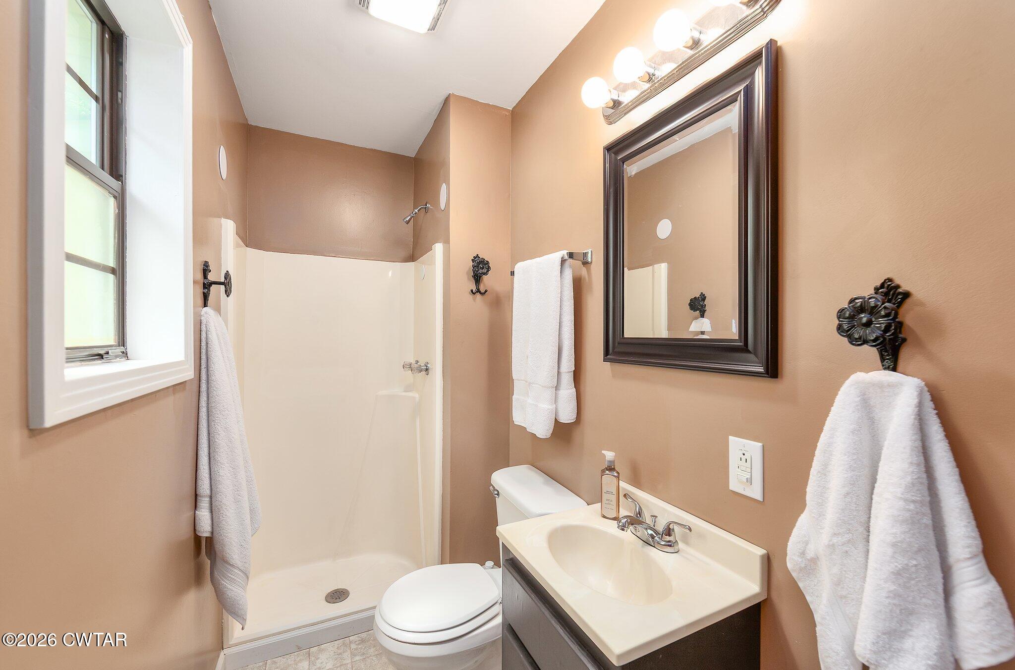 101 Wilde Road Pinson, TN 38366 - Photo 9 of 16 a bathroom with a toilet a sink and a mirror