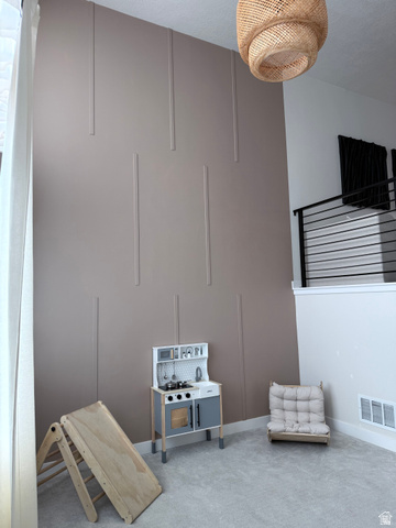 774 West 480 South American Fork, UT 84003 - Photo 51 of 76 Two-story accent wall with vertical paneling, textured ceiling, and recessed lighting