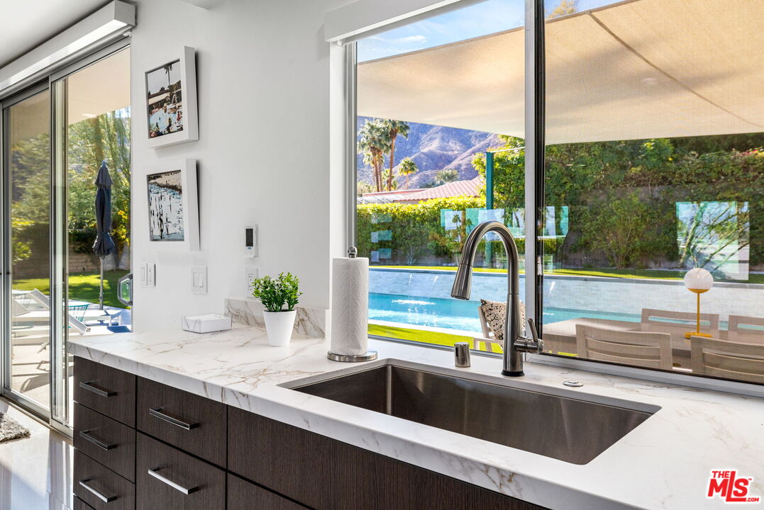 71581 Halgar Road Rancho Mirage, CA 92270 - Photo 17 of 39 a view of a kitchen with a sink and a wooden floor