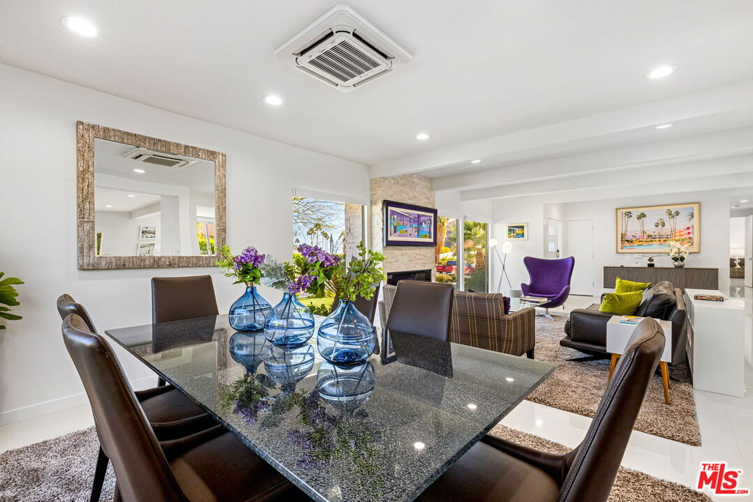 71581 Halgar Road Rancho Mirage, CA 92270 - Photo 18 of 39 a view of a dining room with furniture a rug and wooden floor