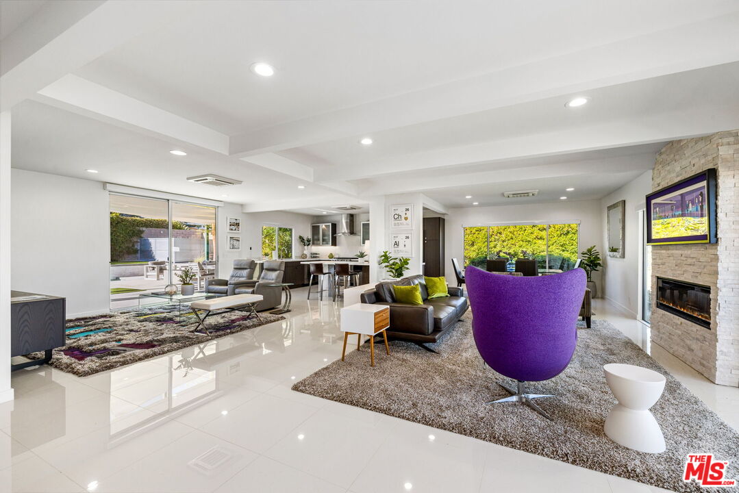 71581 Halgar Road Rancho Mirage, CA 92270 - Photo 8 of 39 a kitchen with stainless steel appliances kitchen island granite countertop a stove and white cabinets