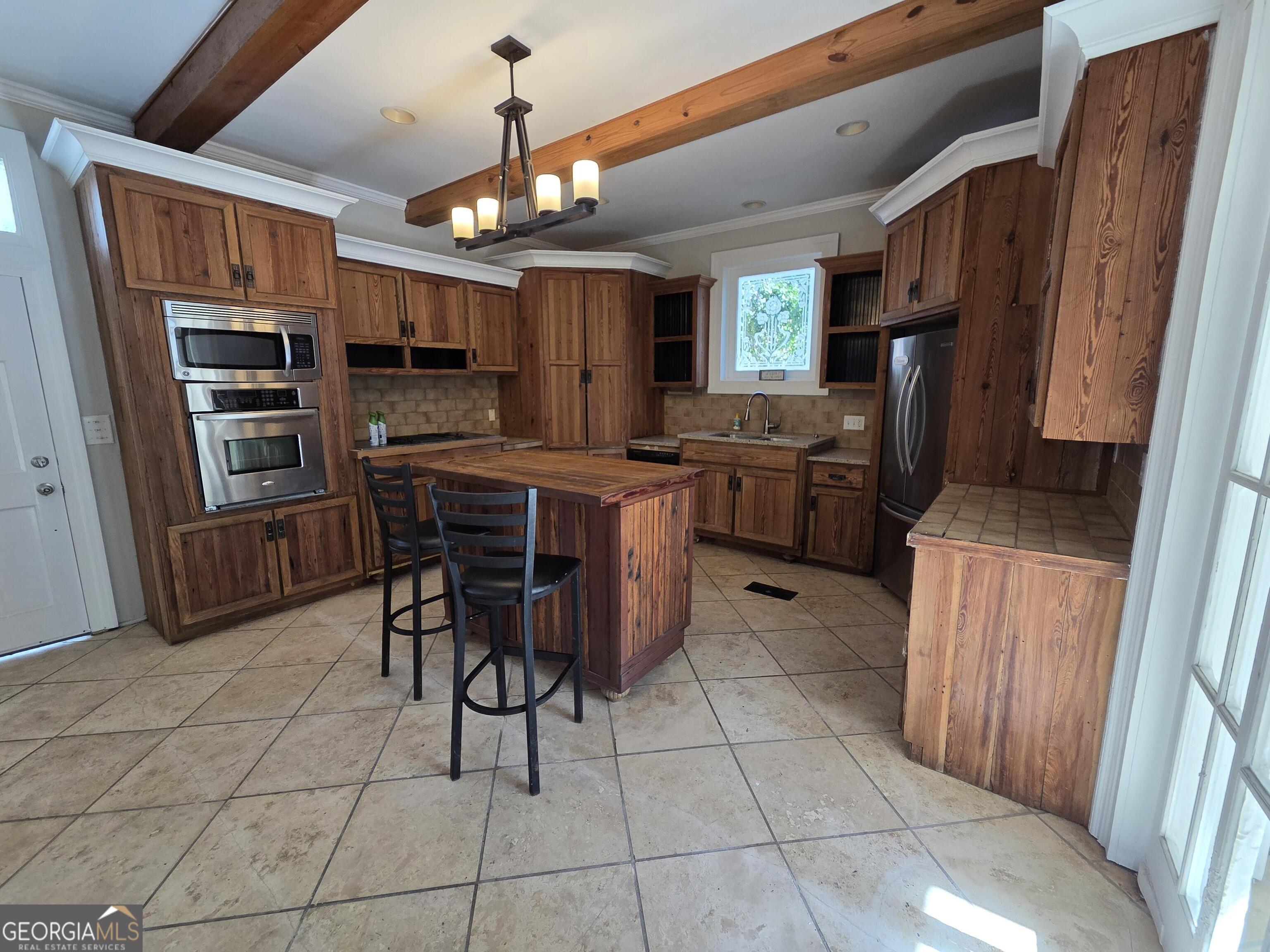 520 Ellis Street Brunswick, GA 31520 - Photo 14 of 48 a kitchen with stainless steel appliances a stove a refrigerator a sink dishwasher and a computer