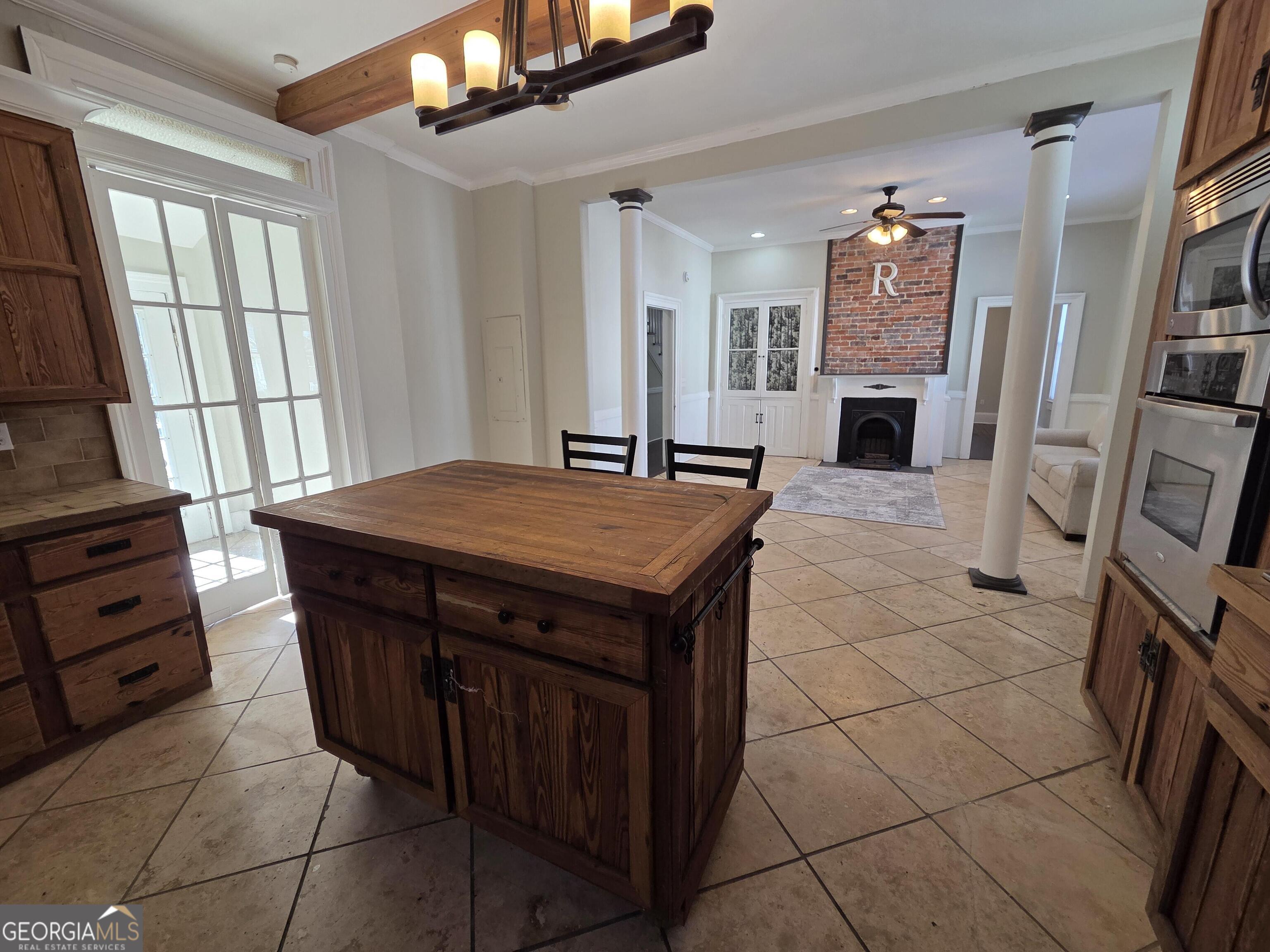 520 Ellis Street Brunswick, GA 31520 - Photo 18 of 48 a kitchen with stainless steel appliances kitchen island granite countertop a sink stove and cabinets