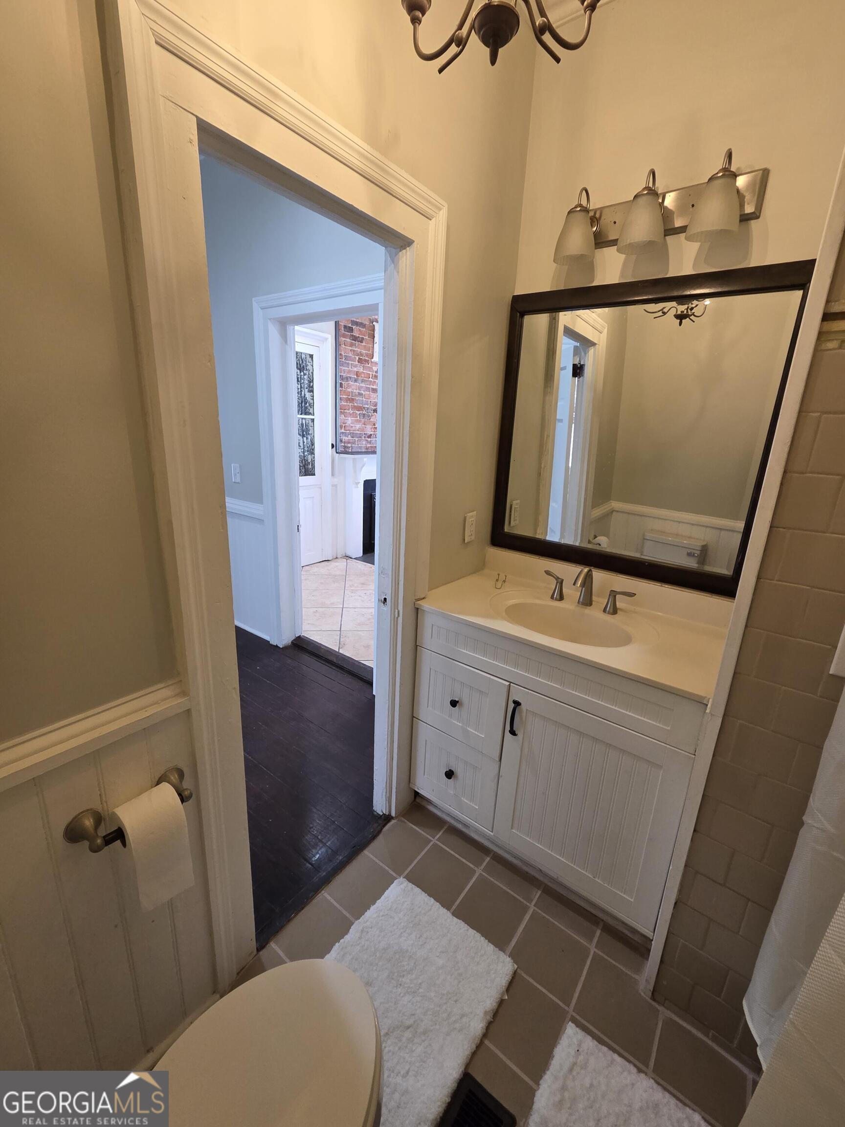 520 Ellis Street Brunswick, GA 31520 - Photo 20 of 48 a bathroom with a sink a toilet and mirror