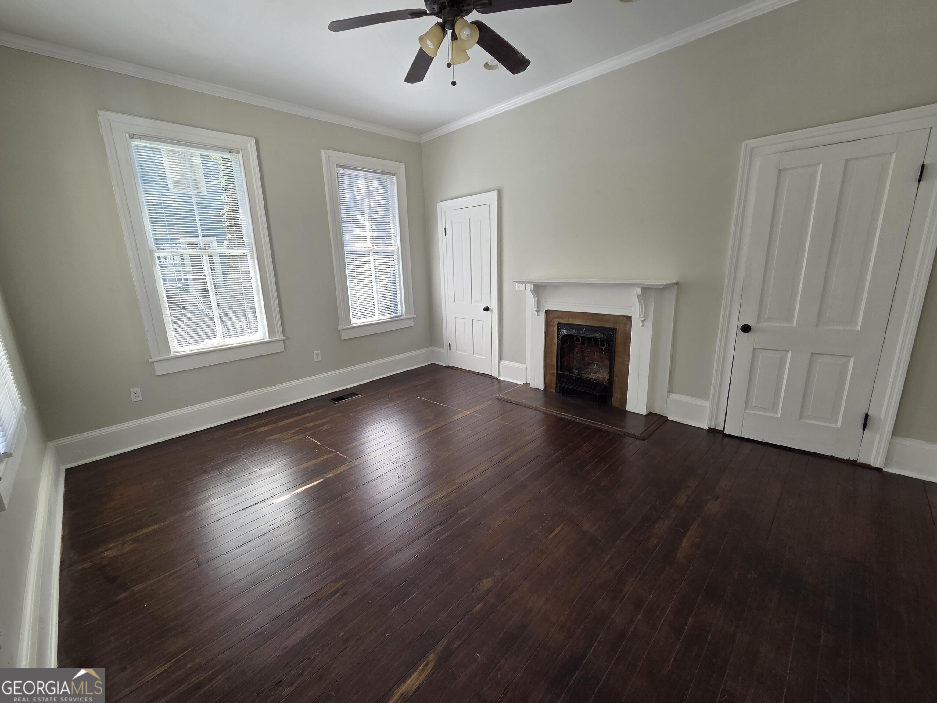 520 Ellis Street Brunswick, GA 31520 - Photo 22 of 48 wooden floor fireplace and windows in an empty room
