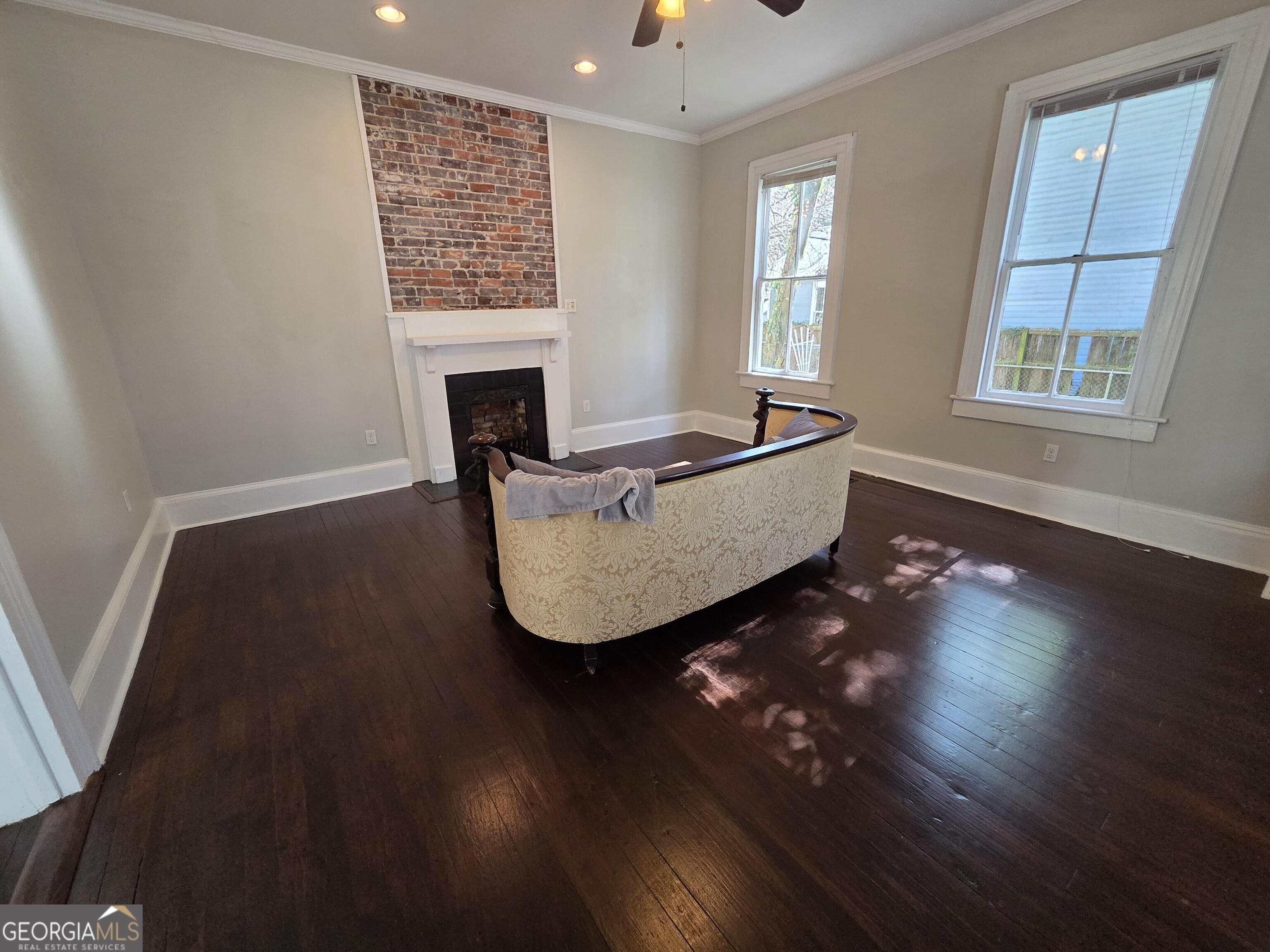 520 Ellis Street Brunswick, GA 31520 - Photo 25 of 48 a living room with furniture and a fireplace