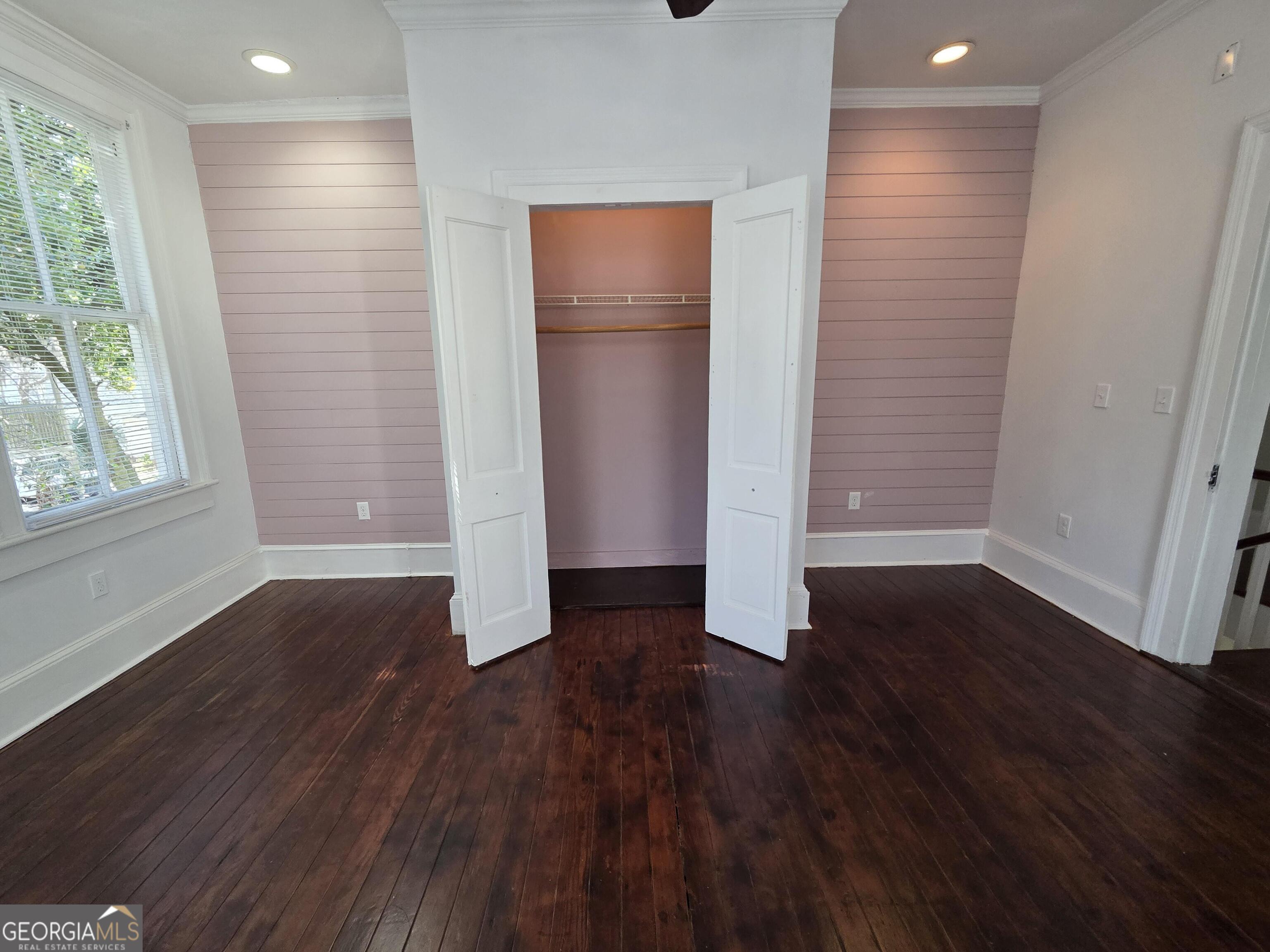 520 Ellis Street Brunswick, GA 31520 - Photo 32 of 48 an empty room with wooden floor and windows