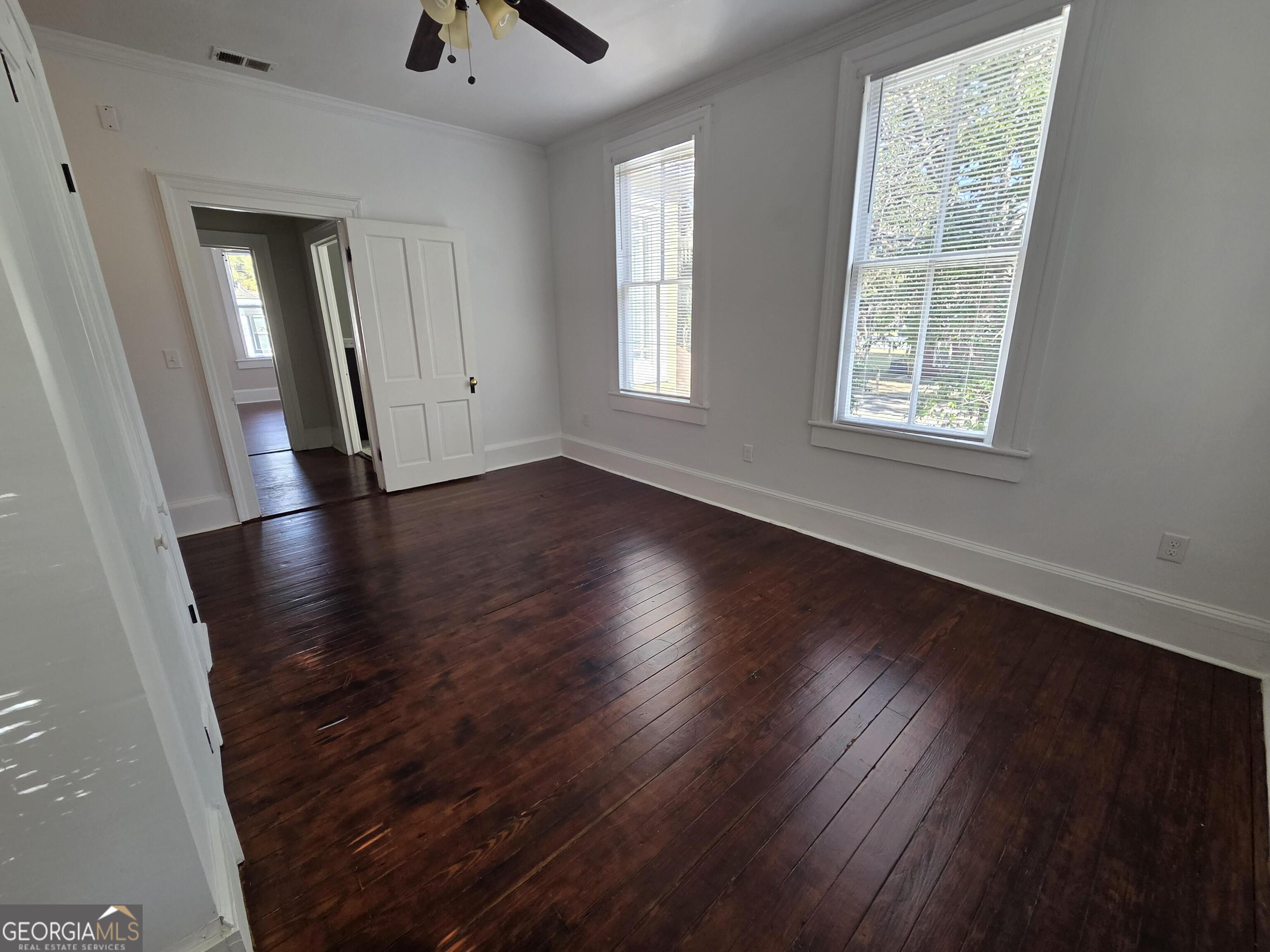 520 Ellis Street Brunswick, GA 31520 - Photo 33 of 48 an empty room with wooden floor and windows