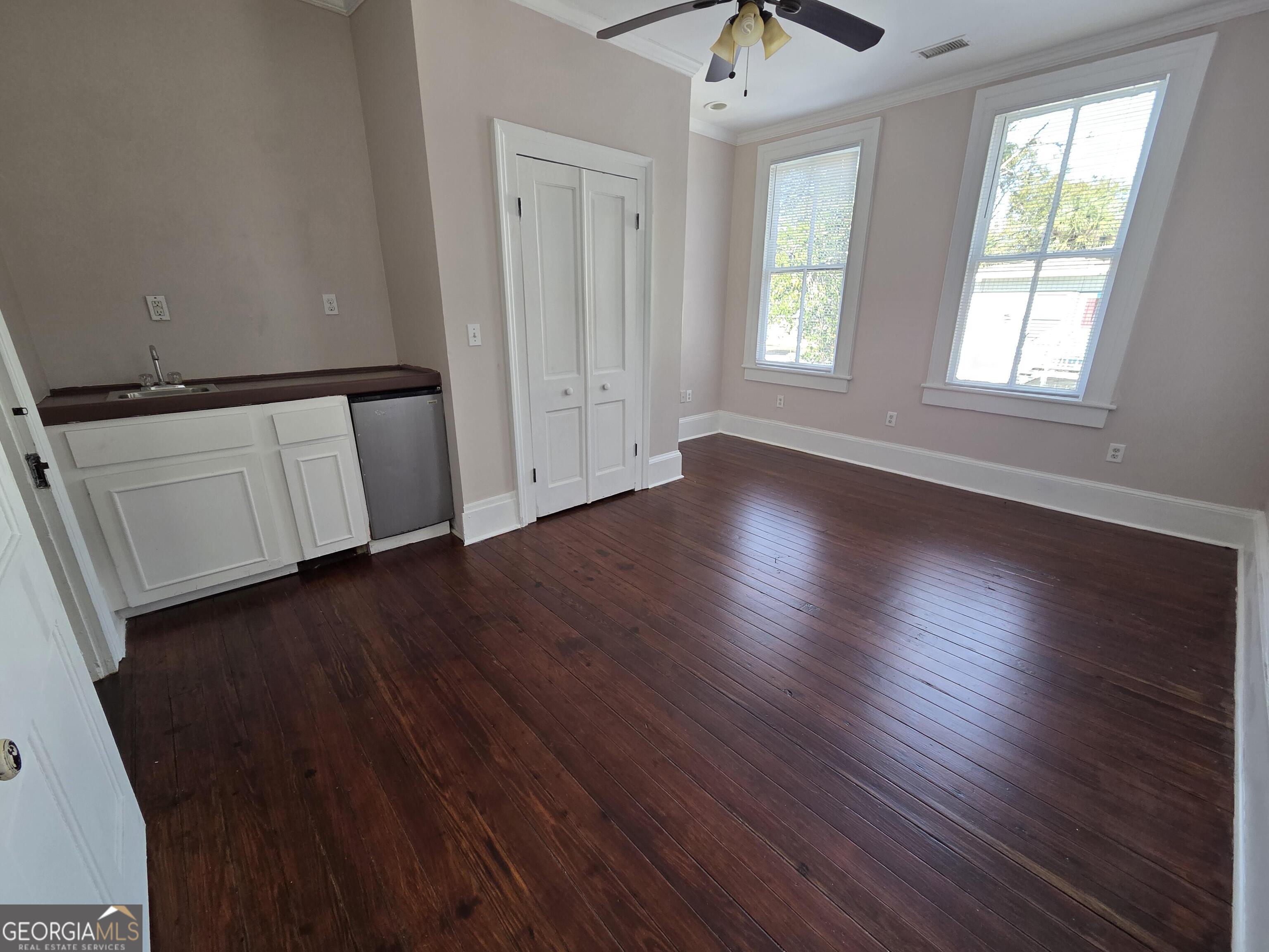 520 Ellis Street Brunswick, GA 31520 - Photo 35 of 48 an empty room with wooden floor and windows