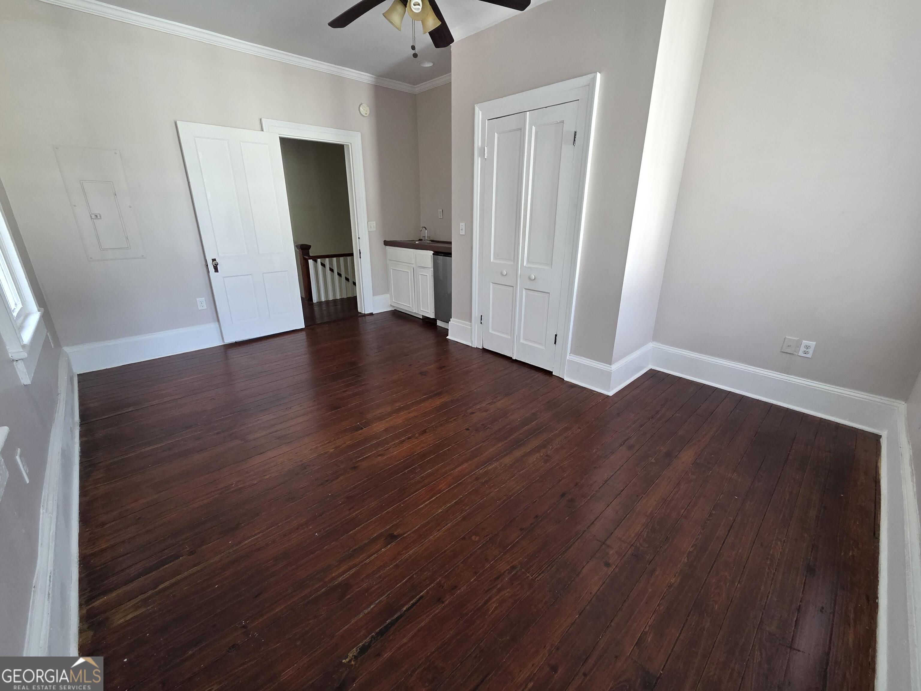 520 Ellis Street Brunswick, GA 31520 - Photo 36 of 48 an empty room with wooden floor and mirror