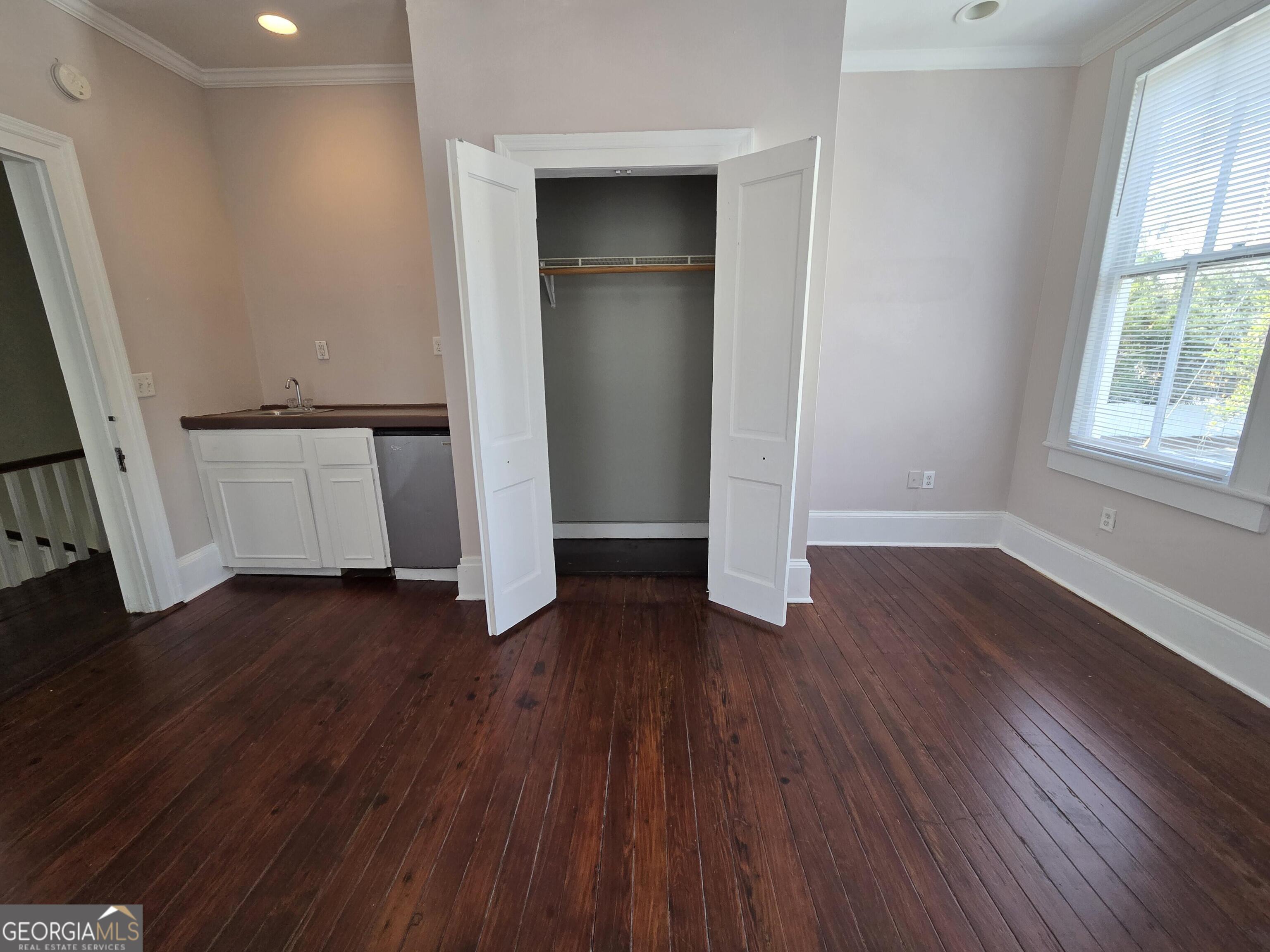 520 Ellis Street Brunswick, GA 31520 - Photo 37 of 48 an empty room with wooden floor and windows