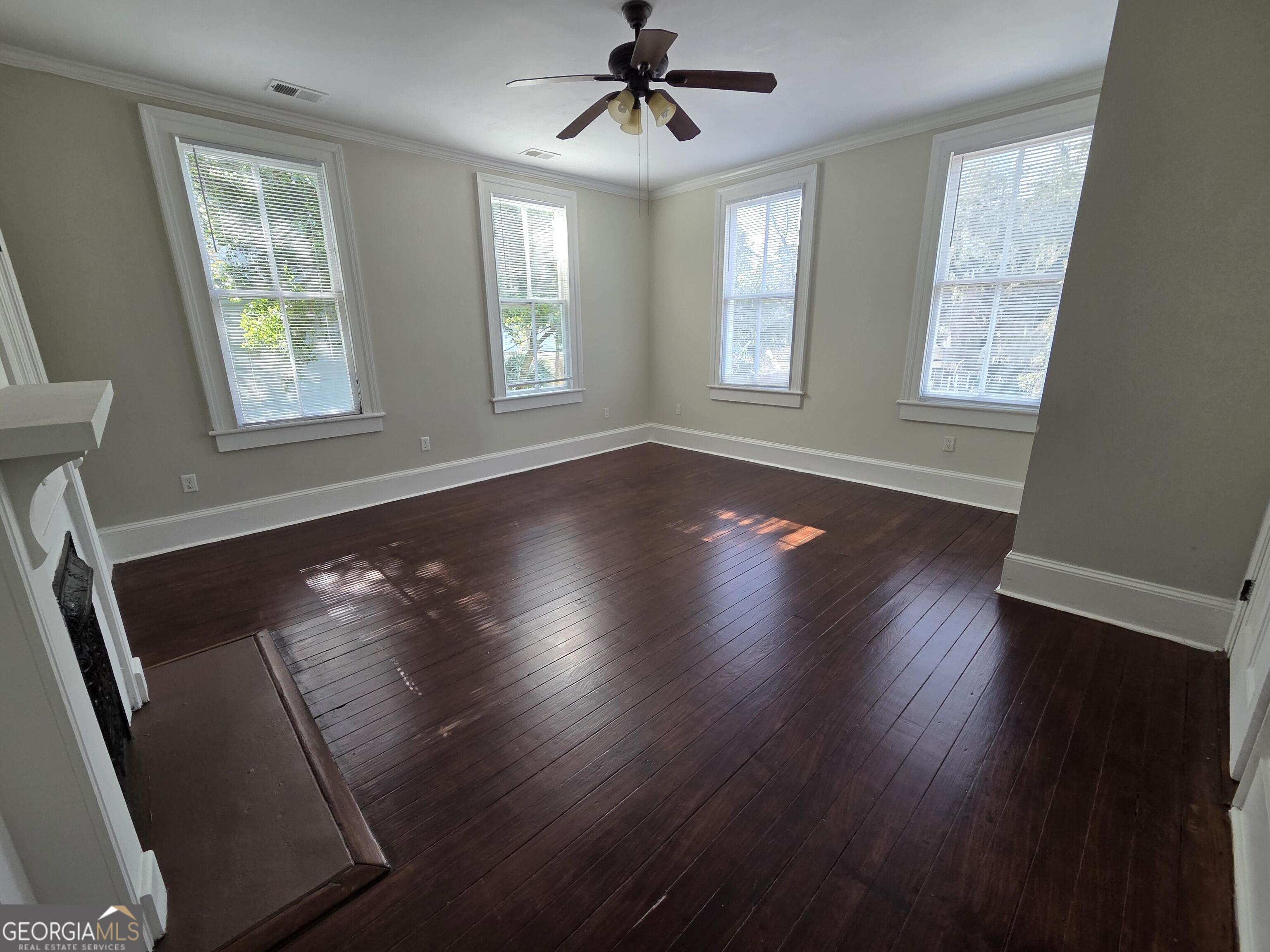 520 Ellis Street Brunswick, GA 31520 - Photo 40 of 48 a view of an empty room with wooden floor and a window