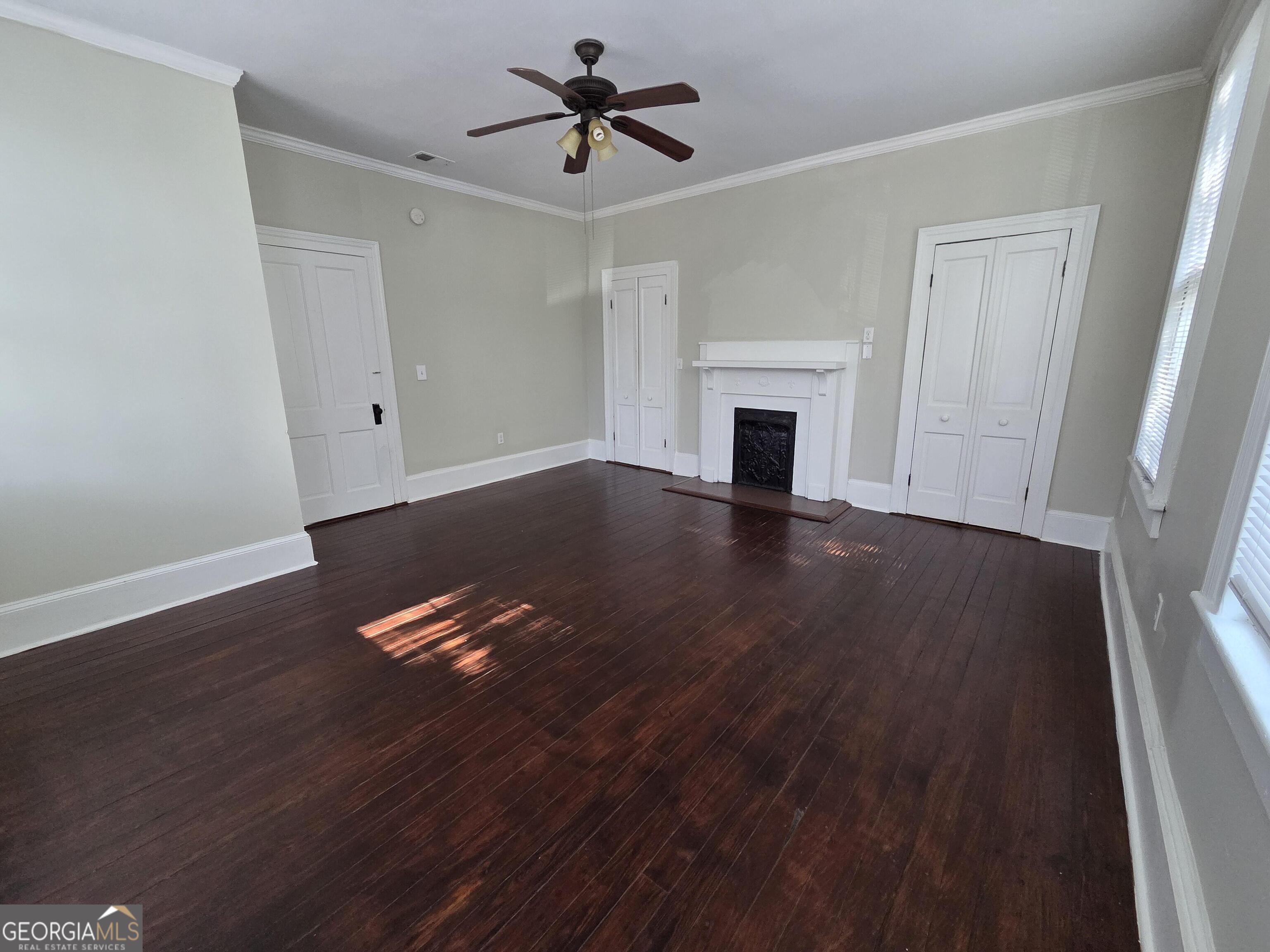 520 Ellis Street Brunswick, GA 31520 - Photo 41 of 48 a view of empty room with wooden floor and fireplace