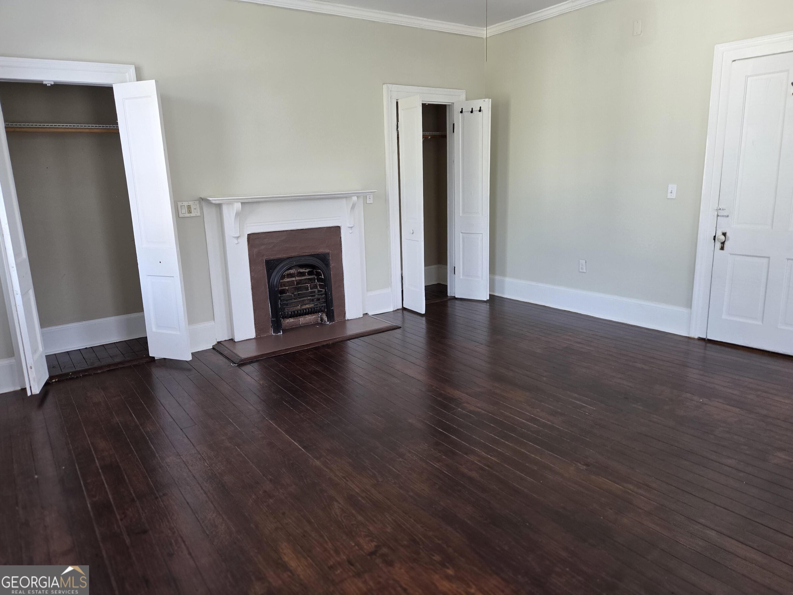520 Ellis Street Brunswick, GA 31520 - Photo 44 of 48 an empty room with wooden floor and fireplace