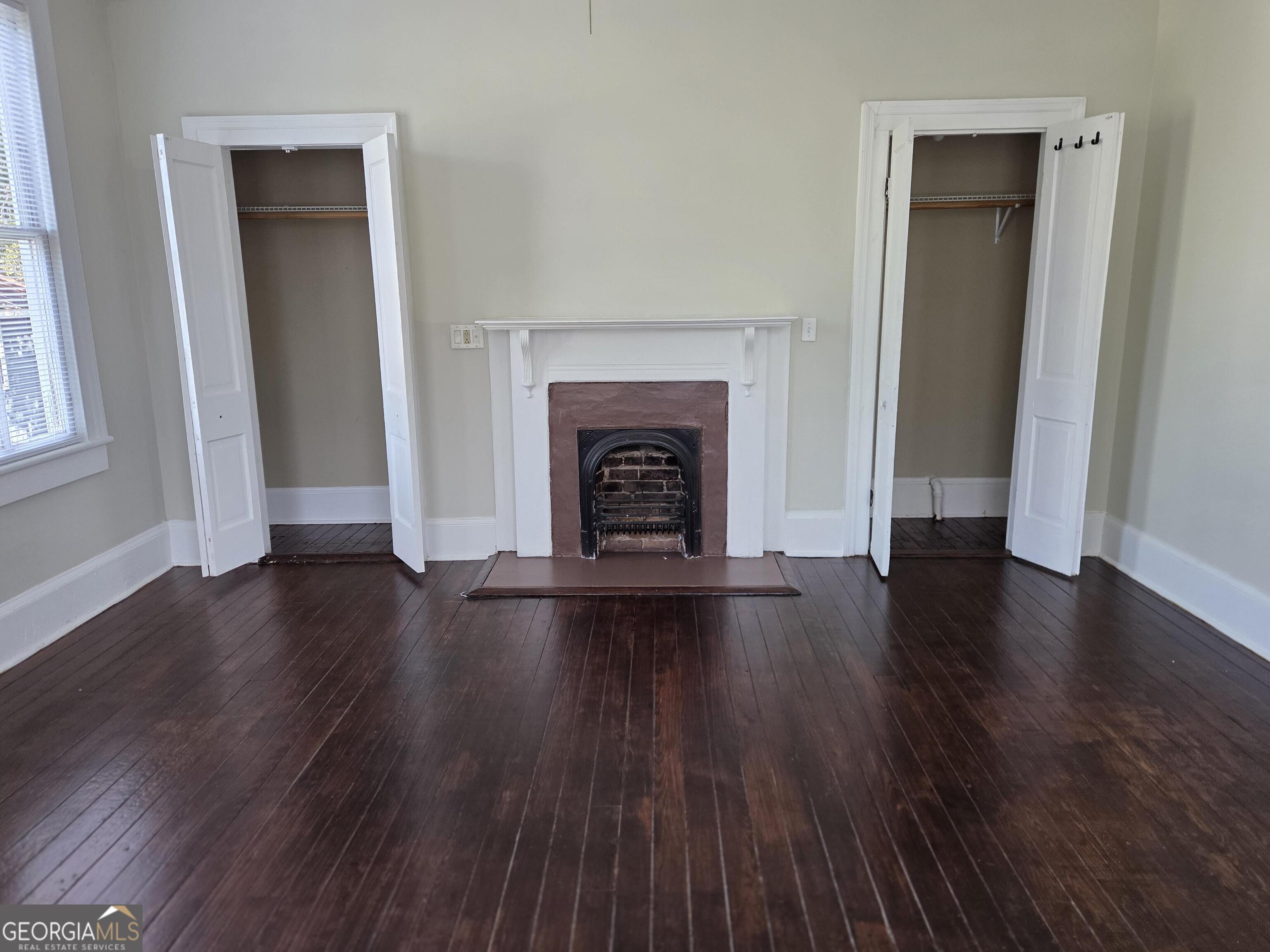 520 Ellis Street Brunswick, GA 31520 - Photo 45 of 48 an empty room with wooden floor and fireplace