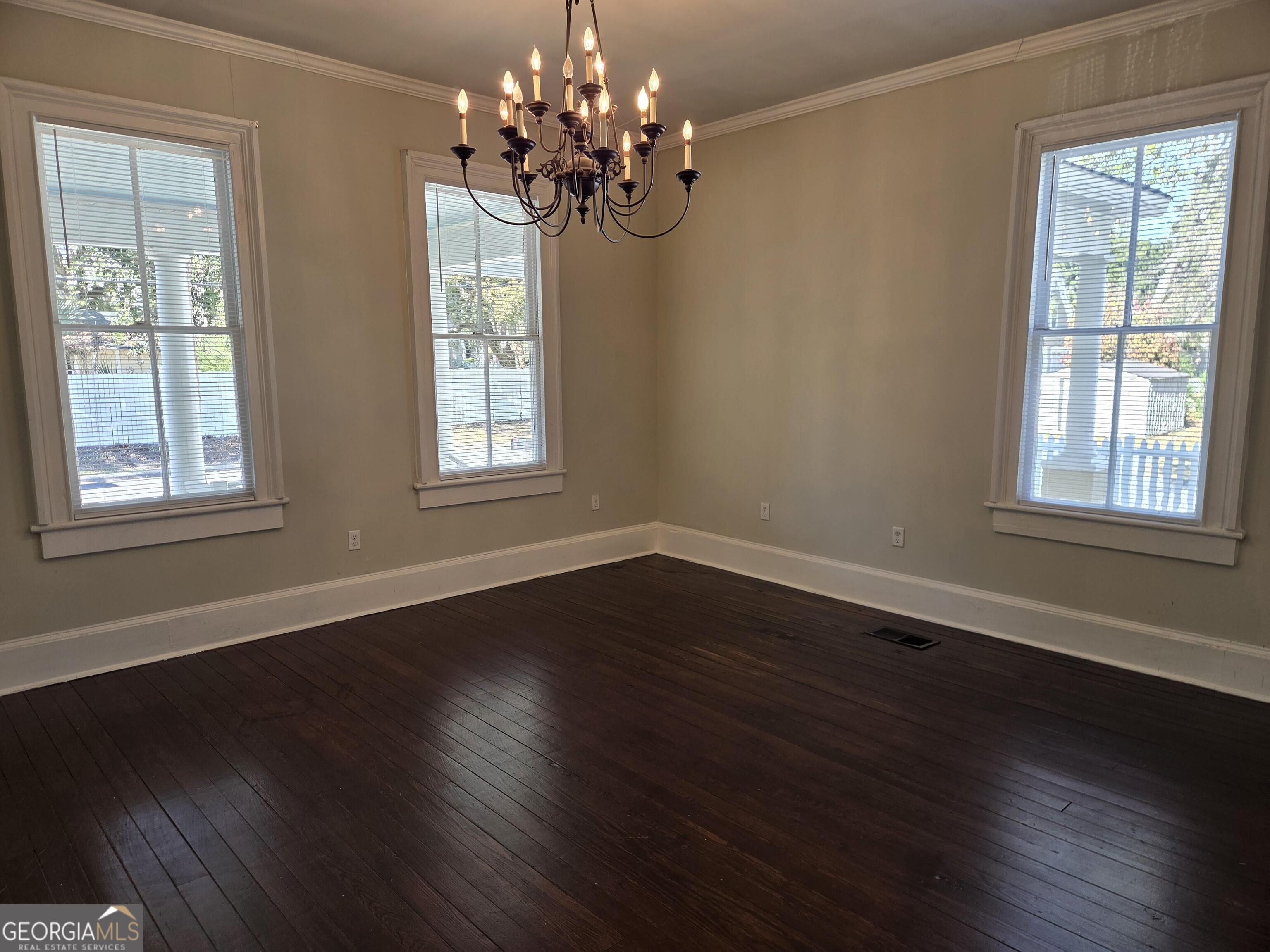 520 Ellis Street Brunswick, GA 31520 - Photo 9 of 48 a view of an empty room with wooden floor and a window