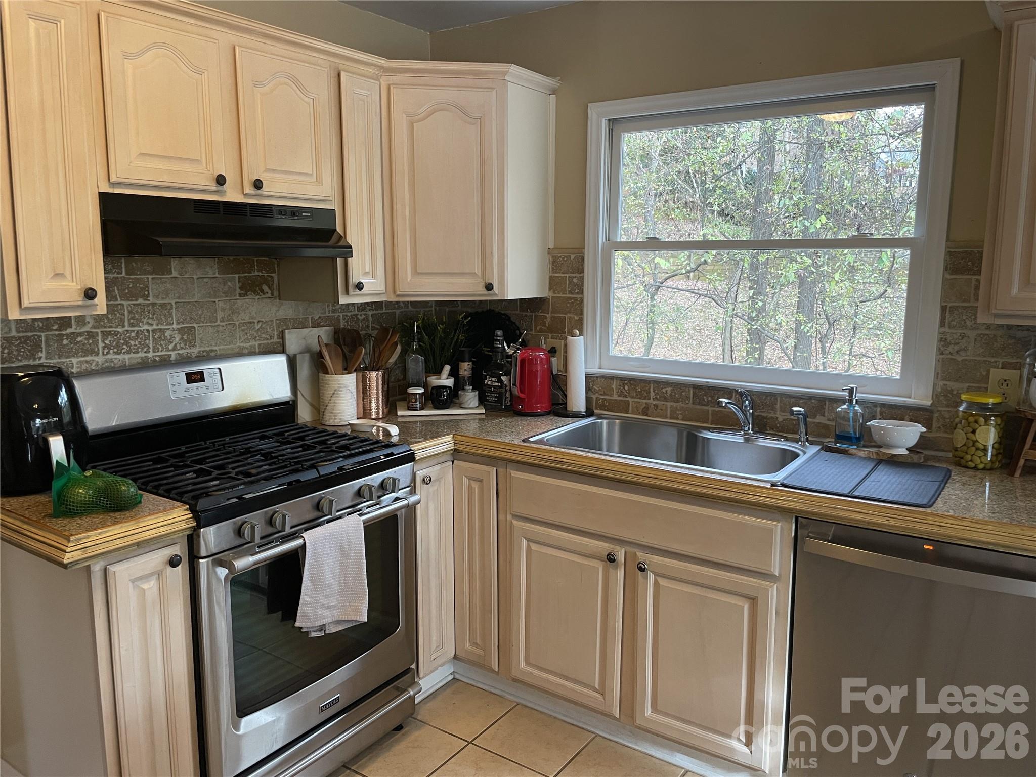 3800 Oldfield Road Charlotte, NC 28226 - Photo 8 of 32 a kitchen with granite countertop a stove sink and cabinets