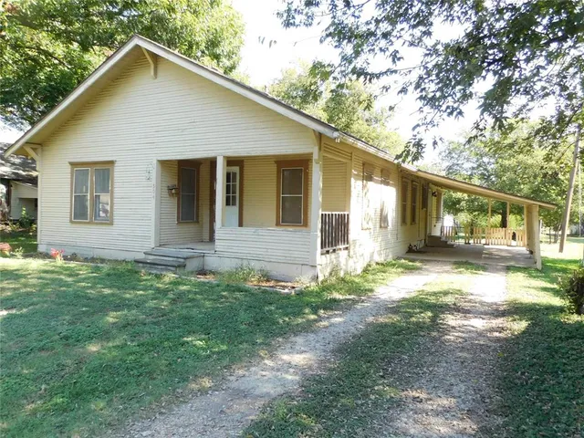 a view of a house with yard and a garden