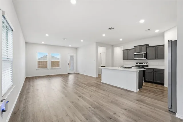 a view of kitchen with sink and refrigerator