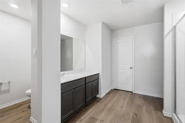 a view of hallway with wooden floor