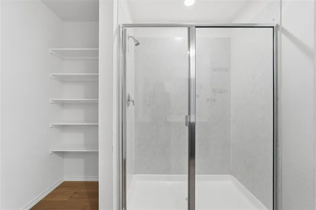 a bathroom with a glass shower door