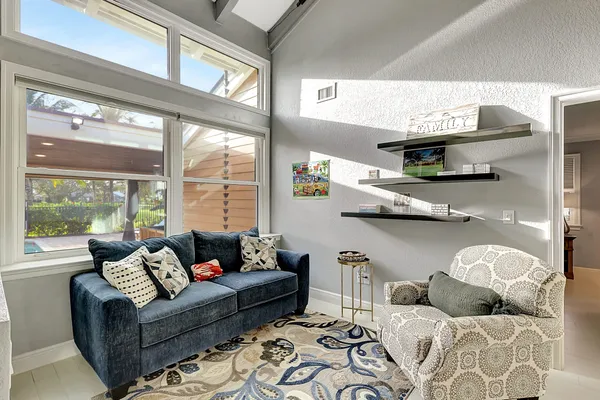 a living room with furniture and a fireplace