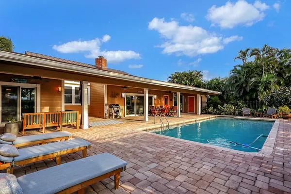 a front view of a house with porch yard fire pit and outdoor seating