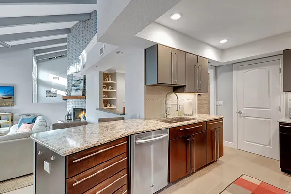 a kitchen with stainless steel appliances granite countertop a refrigerator and a stove top oven
