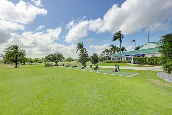 a room with lots of tables a large window and chairs