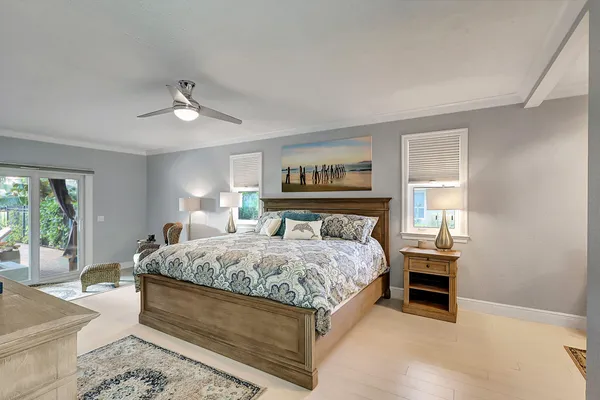 a bedroom with a large bed and a chandelier