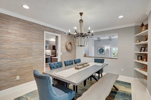 a view of a dining room with furniture and a chandelier