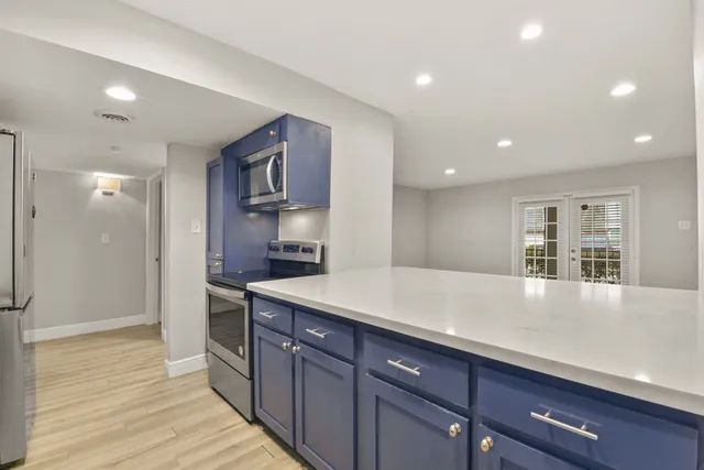 a kitchen with a sink and refrigerator