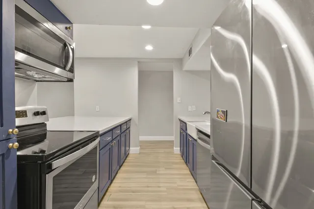 a kitchen with granite countertop a sink and stainless steel appliances