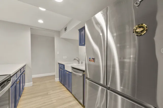 a kitchen with stainless steel appliances granite countertop a refrigerator and a sink