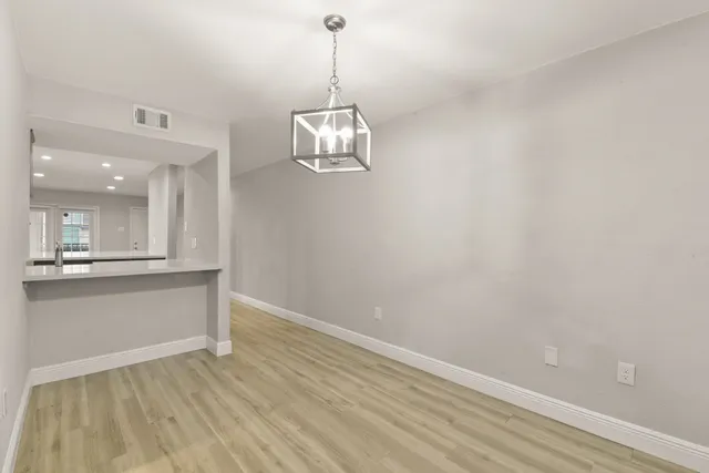 a view of a room with wooden floor and windows