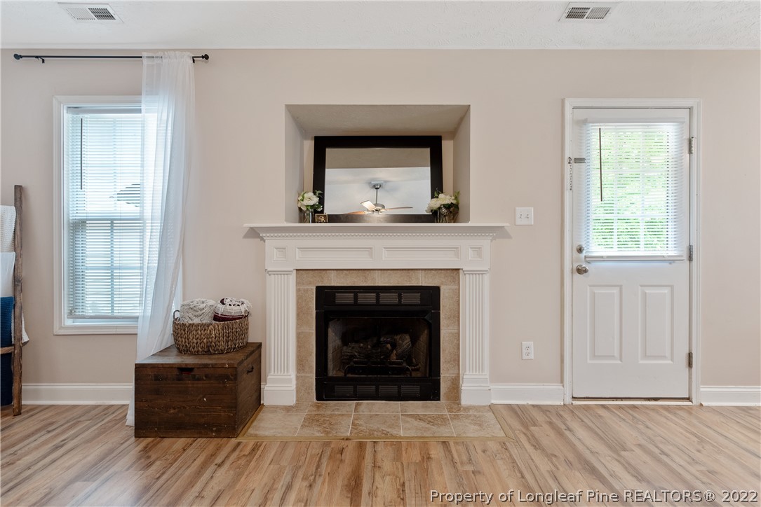 191 Quarry Lane Raeford, NC 28376 - Photo 11 of 42 a living room with a fireplace and a window
