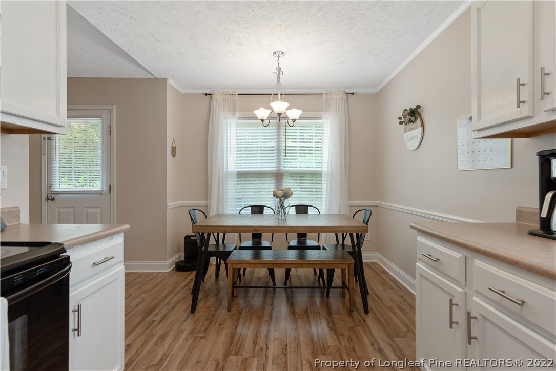 191 Quarry Lane Raeford, NC 28376 - Photo 13 of 42 a view of a dining room with furniture window and wooden floor