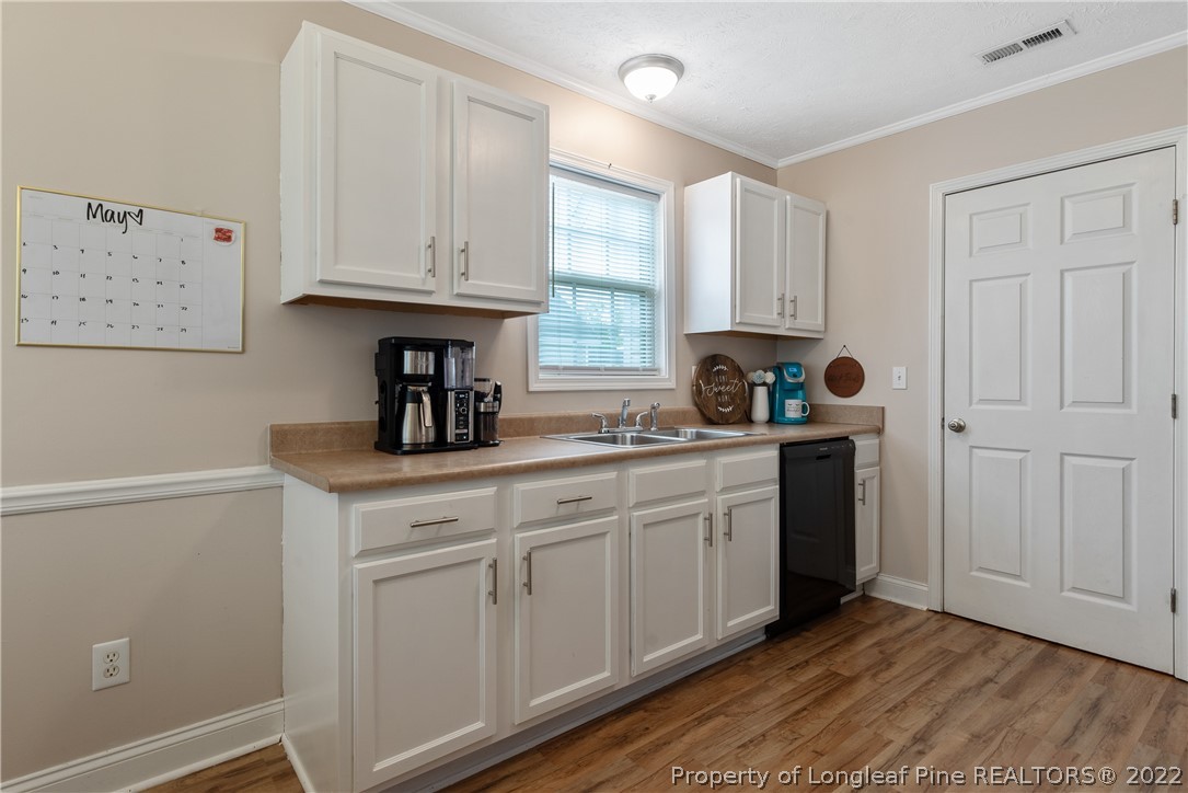 191 Quarry Lane Raeford, NC 28376 - Photo 15 of 42 a kitchen with white cabinets and sink