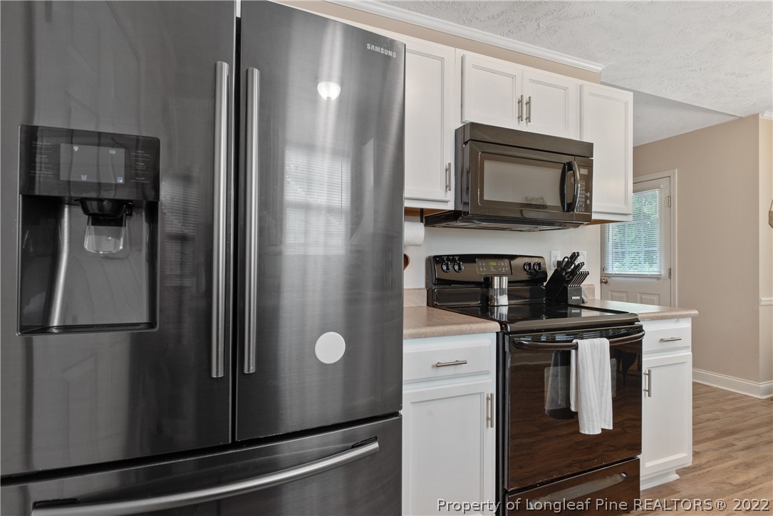 191 Quarry Lane Raeford, NC 28376 - Photo 17 of 42 a kitchen with a refrigerator stove and microwave