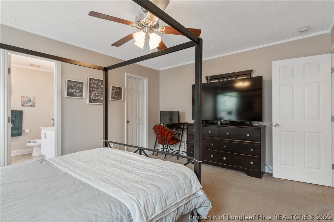 191 Quarry Lane Raeford, NC 28376 - Photo 22 of 42 a bedroom with a bed and a flat screen tv