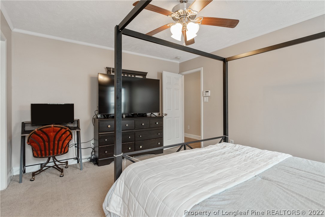 191 Quarry Lane Raeford, NC 28376 - Photo 23 of 42 a bedroom with a bed and a chandelier