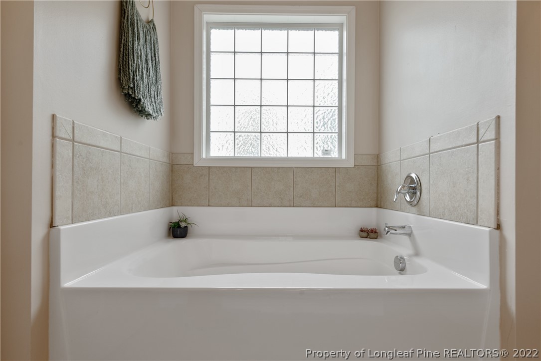 191 Quarry Lane Raeford, NC 28376 - Photo 27 of 42 a white bath tub sitting in a bathroom next to a window